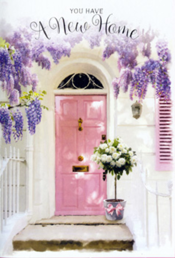 The photograph shows a welcoming doorway in Brent turned into a gentle floral scene, perfectly suited to mark a new set of keys and a fresh address somewhere between Kilburn and Neasden. The centre of the composition is a pastel pink front door whose surface is bathed in soft, even daylight. The colour is warm but not loud, like a comforting blush that hints at personality without overwhelming the senses. Whitewashed walls flank the door and seem to bounce the light back, making the entrance feel bright, open, and inviting. A single pink shutter painted in the same tone creates symmetry and connects the architectural elements with a subtle charm reminiscent of tidy terraces near Mapesbury. Overhead, a luxuriant cascade of wisteria pours down from above the frame. The blossoms are a powdery lavender, gathered into long, pendulous clusters that sway slightly in the imagined breeze. Leaves intersperse the flowers, casting shifting, dappled shadows that dance across the door and stone. Resting on the doorstep is a grey metal bucket, ordinary in structure yet elevated by what it holds. Inside, plush white and cream roses crowd together in a generous arrangement, their velvety petals unfolding in layered spirals. Sprigs of fresh green foliage peek out between the blooms, softening the edges and adding depth. Around the lower part of the bucket, a satin pink ribbon has been tied into a neat bow, its sheen echoing the warmth of the front door. The entire scene evokes the feeling of a housewarming bouquet personally delivered by a local Brent florist: intimate, heartfelt, and brimming with quiet hope. It suggests that the doorway will soon hear laughter, clinking glasses, and the welcoming footsteps of friends and family crossing the threshold for the first time.